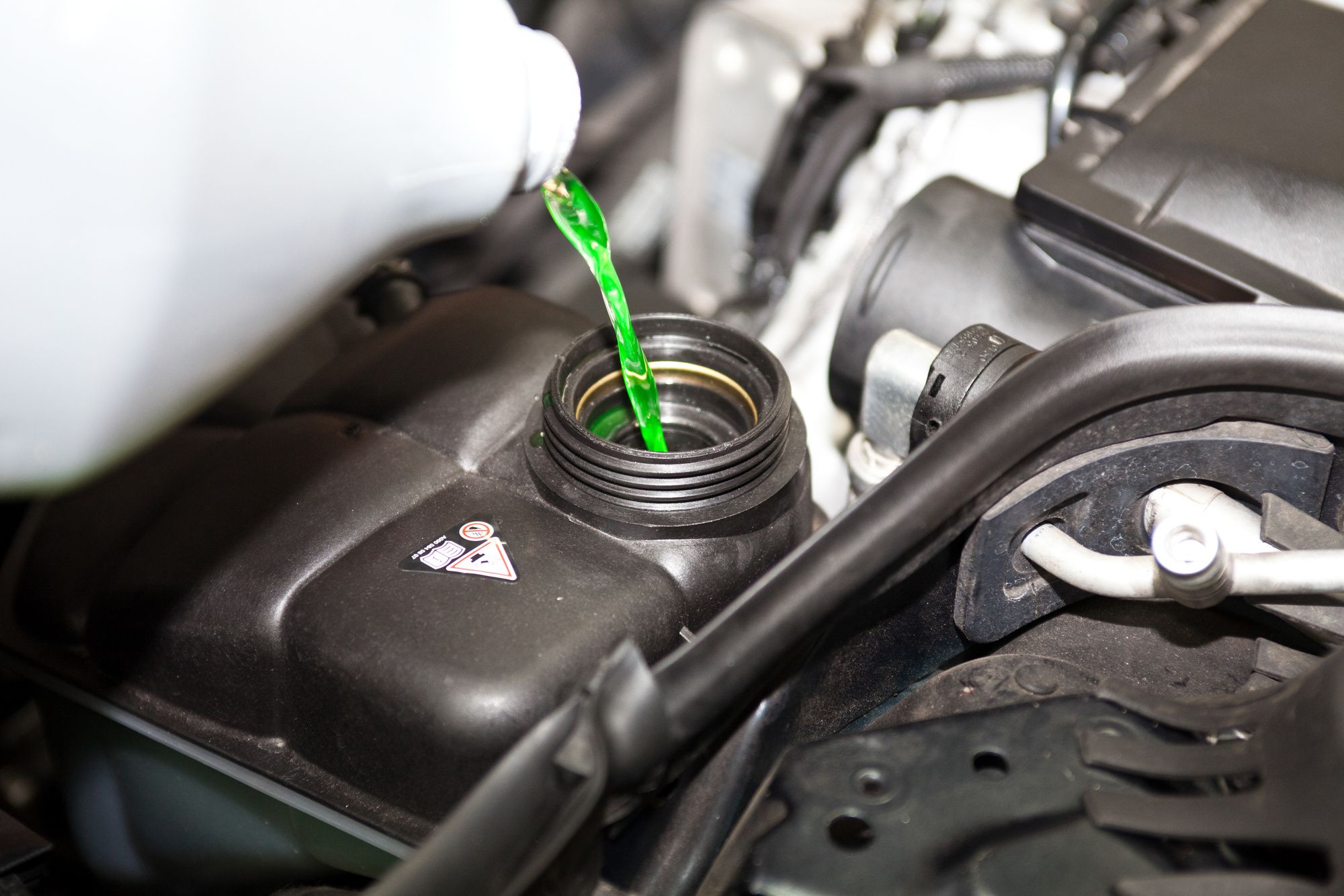 fluid being poured into car