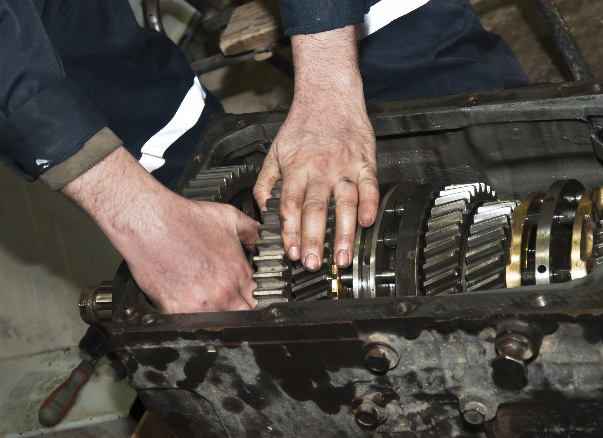 Person Fixing Car Transmission Problems