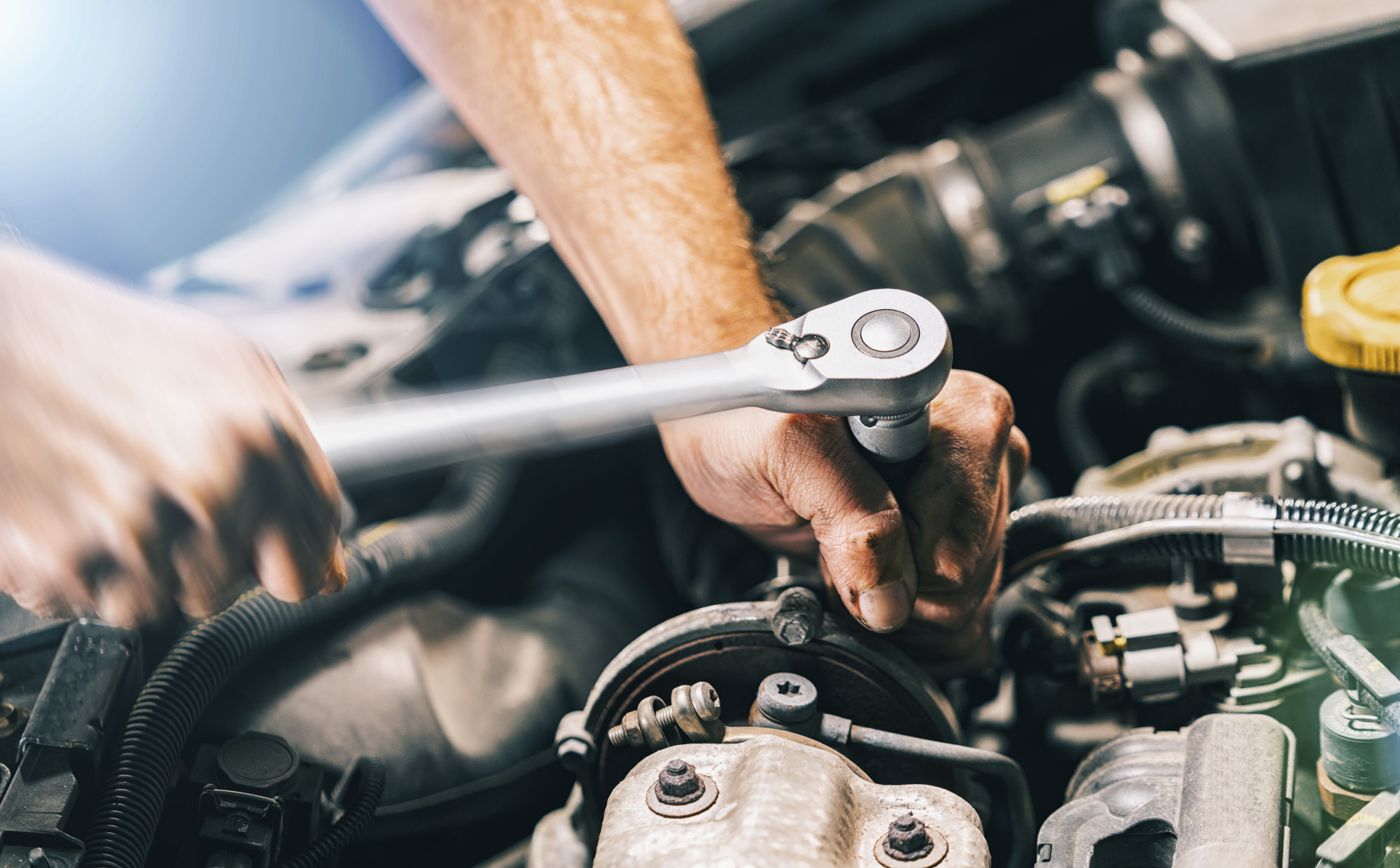 Person Fixing a Car's Engine