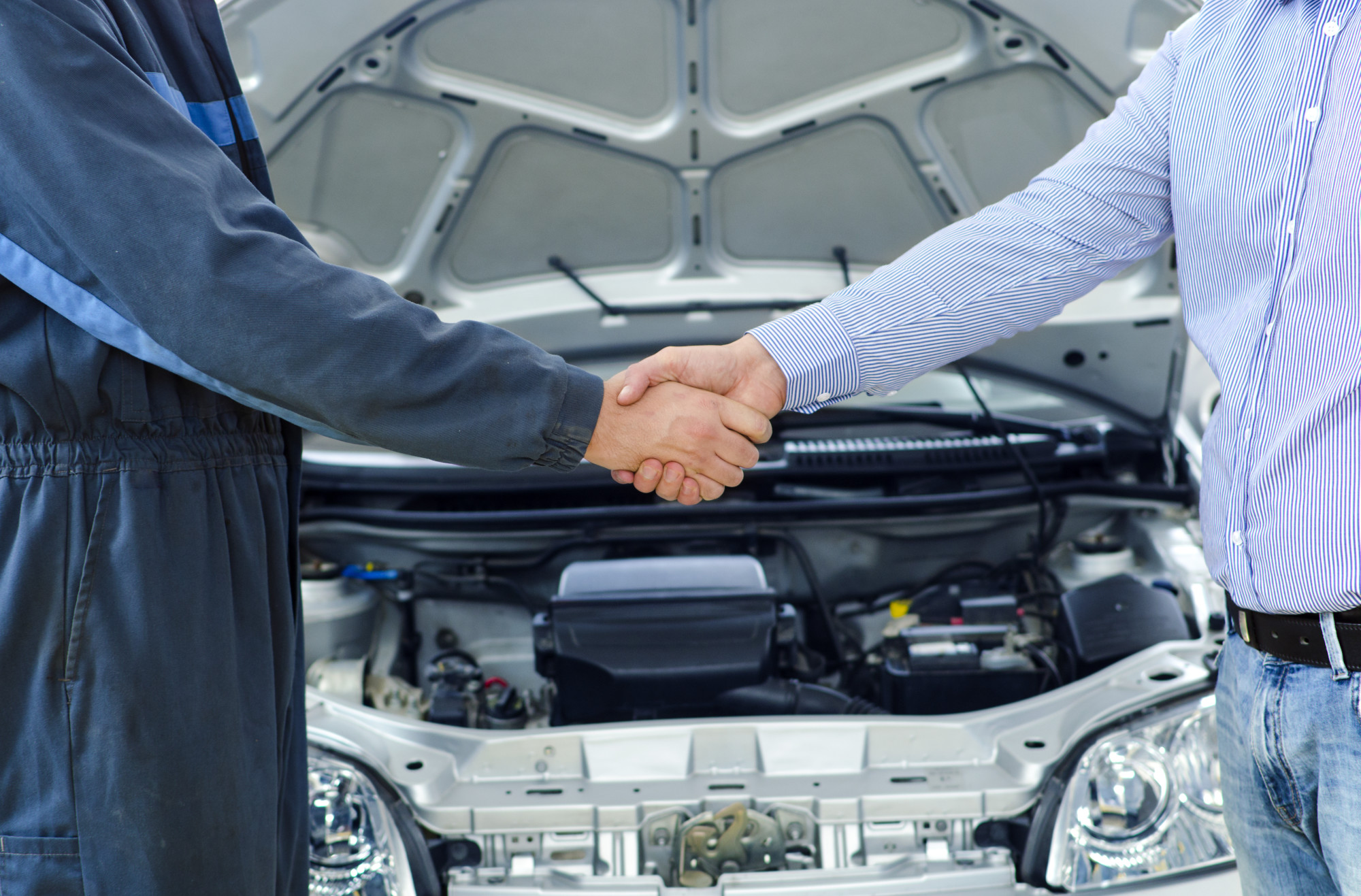 Customer Shaking Hand of Mechanic After Fixing His car Successfully